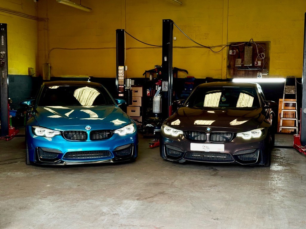 Two BMW performance cars in the Aline Motor Care workshop, Birmingham